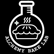 A logo featuring a black background with a white outline of a laboratory flask. Inside the flask outline, there is a steaming pie and a small sparkle to the left. Below the flask, the text "Alchemy Bake Lab" is written in a curved, white font.